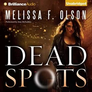 Dead Spots audiobook cover showing a white woman with brown hair walking along a dark alley