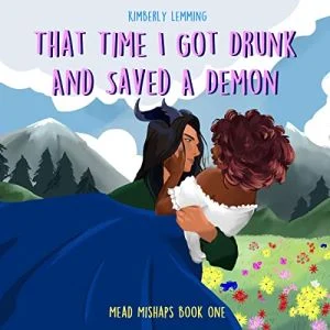 That Time I Got Drunk and Saved a Demon has an illustrated cover showing a white-skinned demon with black hair and curved horns carrying a Black woman with curls wearing a white blouse and long blue skirt, they are on a colorful meadow with flowers, the background shows mountains and trees