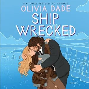 Ship Wrecked audiobook cover shows a white woman with long blonde hair and a bearded white man with dark hair kissing, he is wearing a suit, she is wearing a Viking costume
