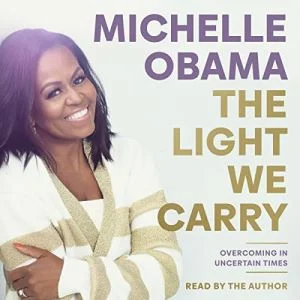 The Light We Carry audiobook cover showing Michelle Obama smiling at the camera
